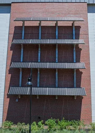 Four rows of solar cells on a side of the Commons building